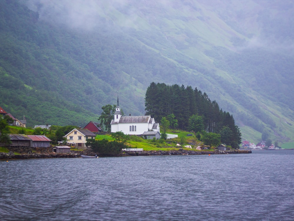 a body of water with buildings and trees by it