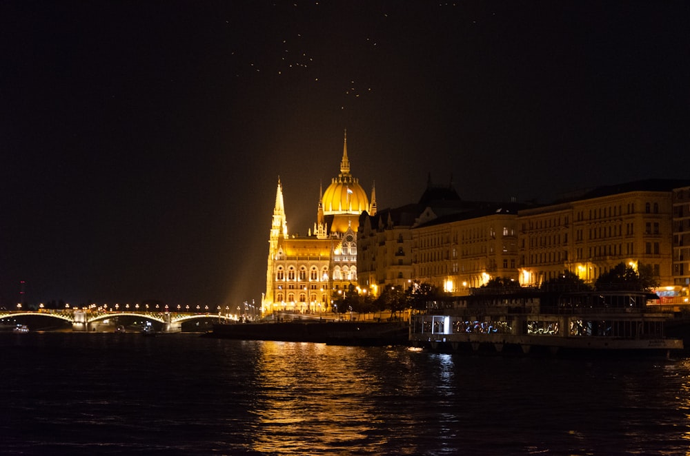 a city with a bridge and water at night