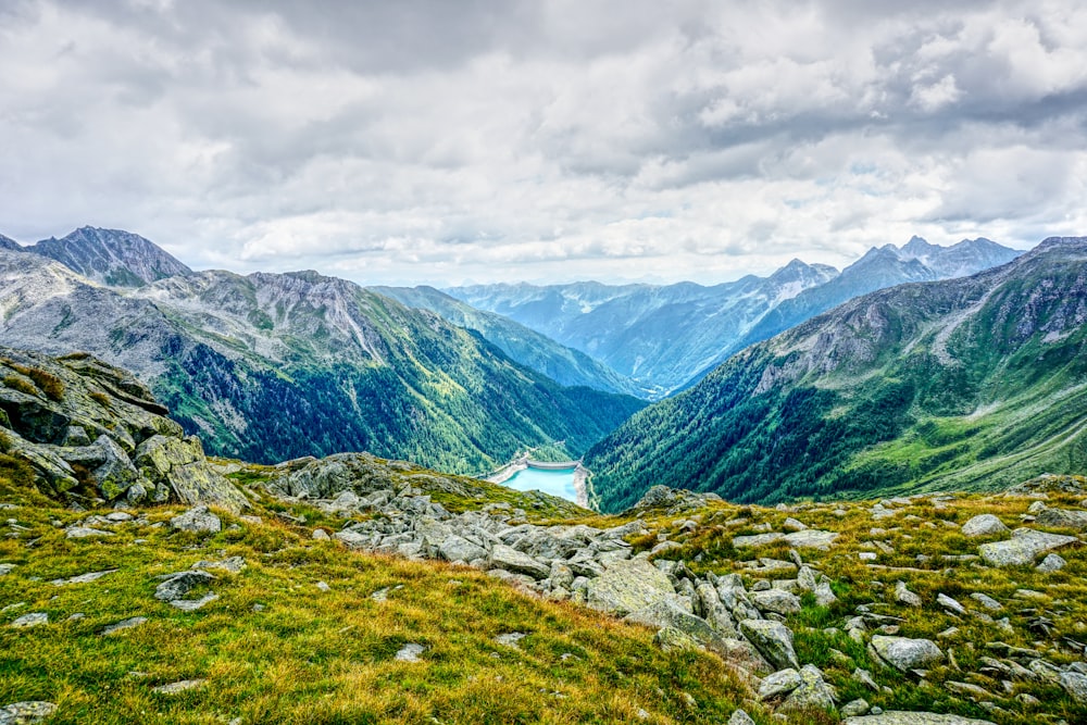 a valley with mountains in the background