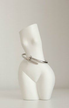 a white lamp with a silver shade