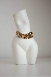a white candle with a gold ring