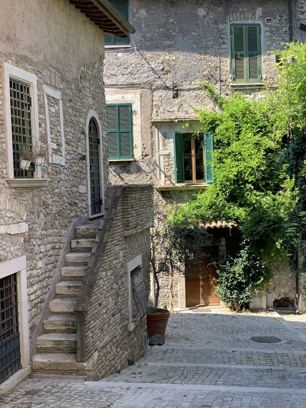 a stone building with green windows