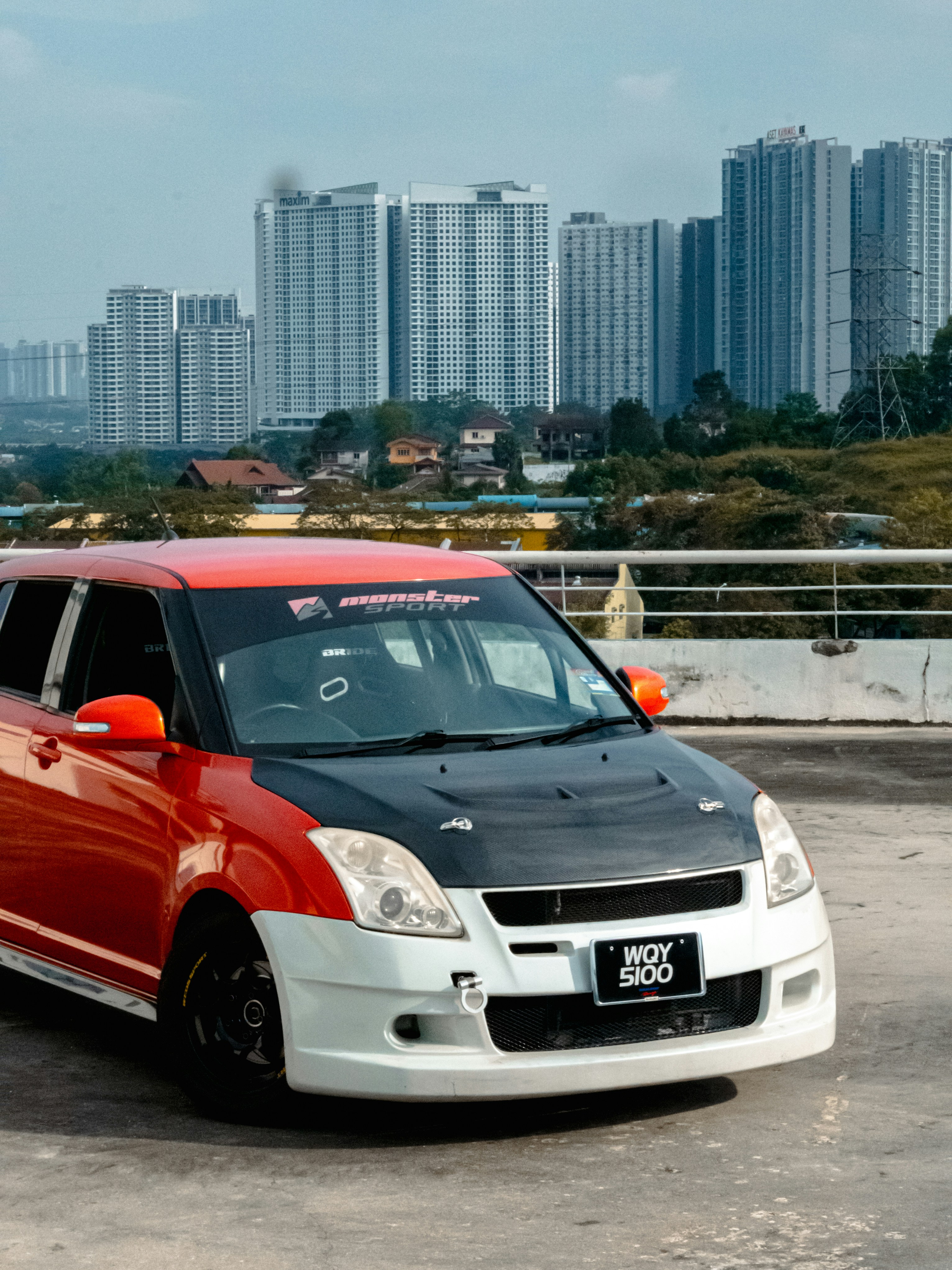 a car parked on a road with a city in the background