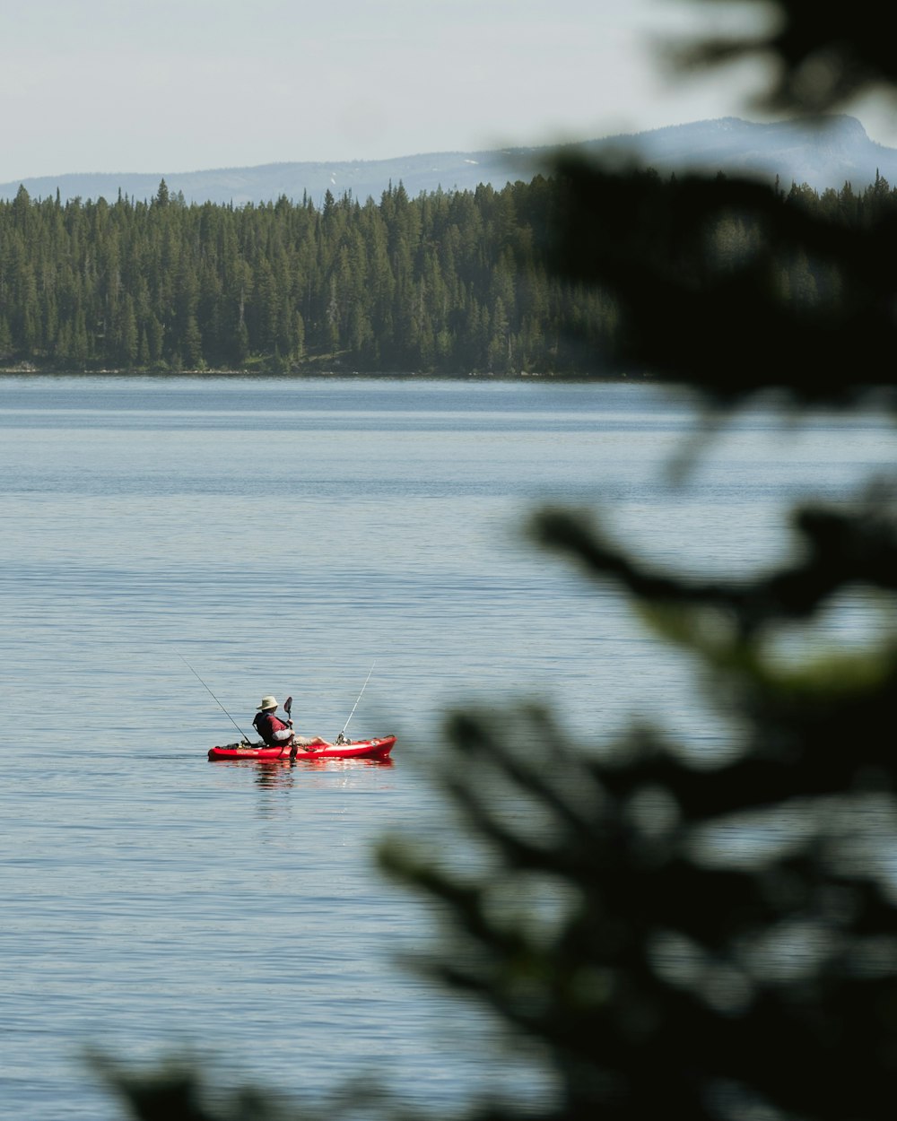 a person in a kayak on a lake