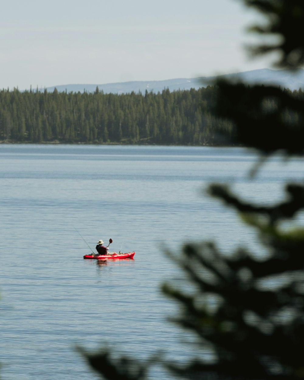 a person in a kayak on a lake