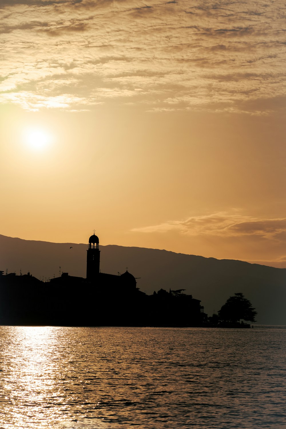 a body of water with a lighthouse on the shore