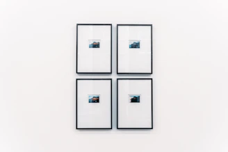 Elegant display of framed photographic prints arranged neatly on a minimalist wall.