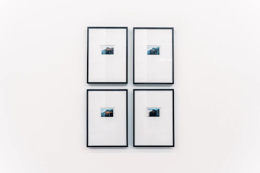 Elegant display of framed photographic prints arranged neatly on a minimalist wall.