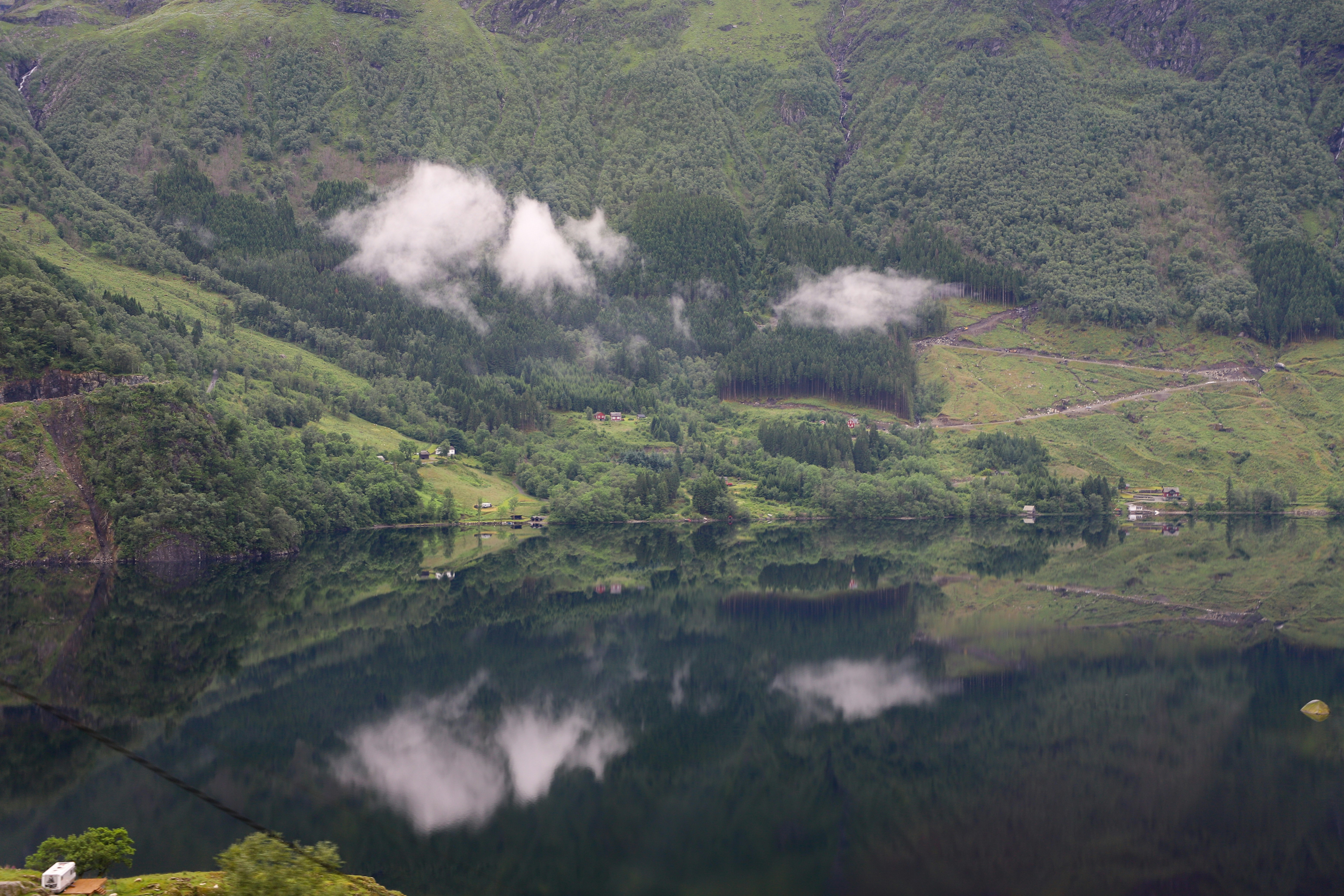 a lake surrounded by hills and trees