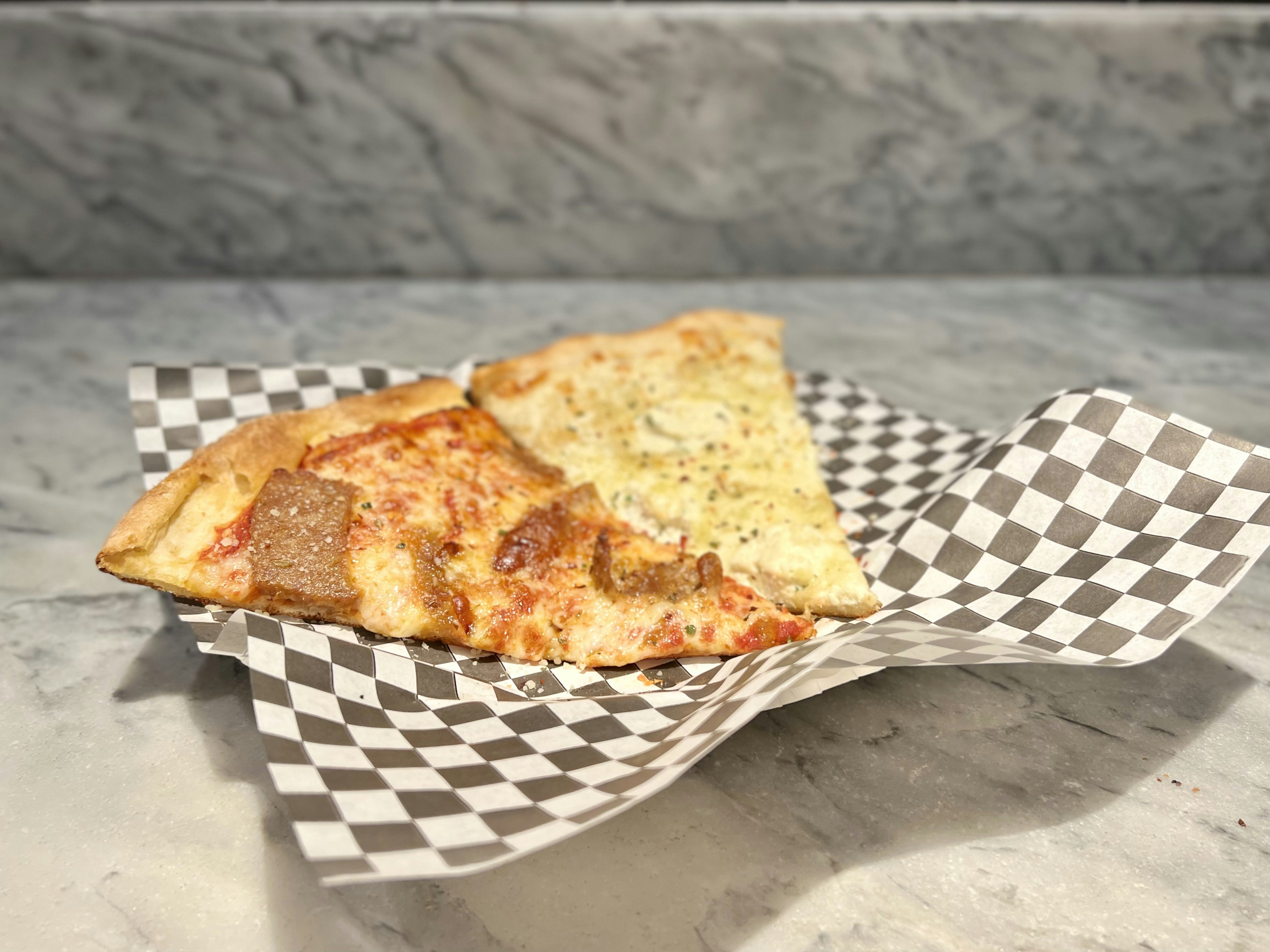 Slice of pizza on checked paper