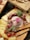 A close-up of assorted cheeses and cold cuts on a wooden board.