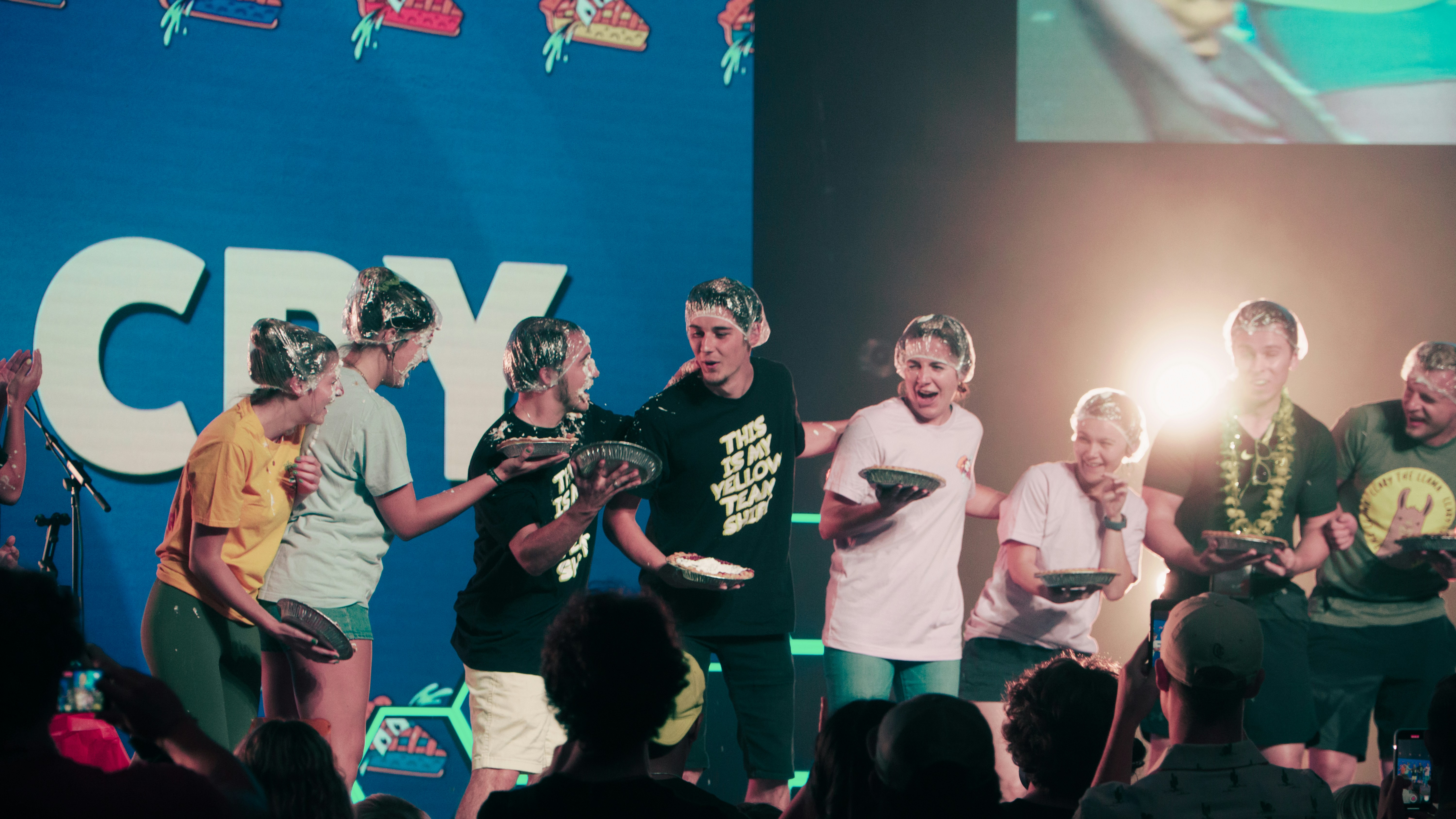 a group of people wearing green shirts