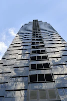 A modern skyscraper reflecting the sky, symbolizing growth and ambition.
