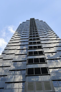 A modern skyscraper reflecting the sky, symbolizing growth and ambition.