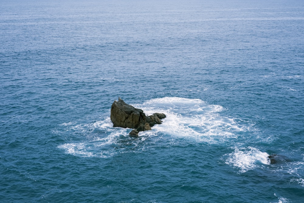 a rock in the middle of the ocean