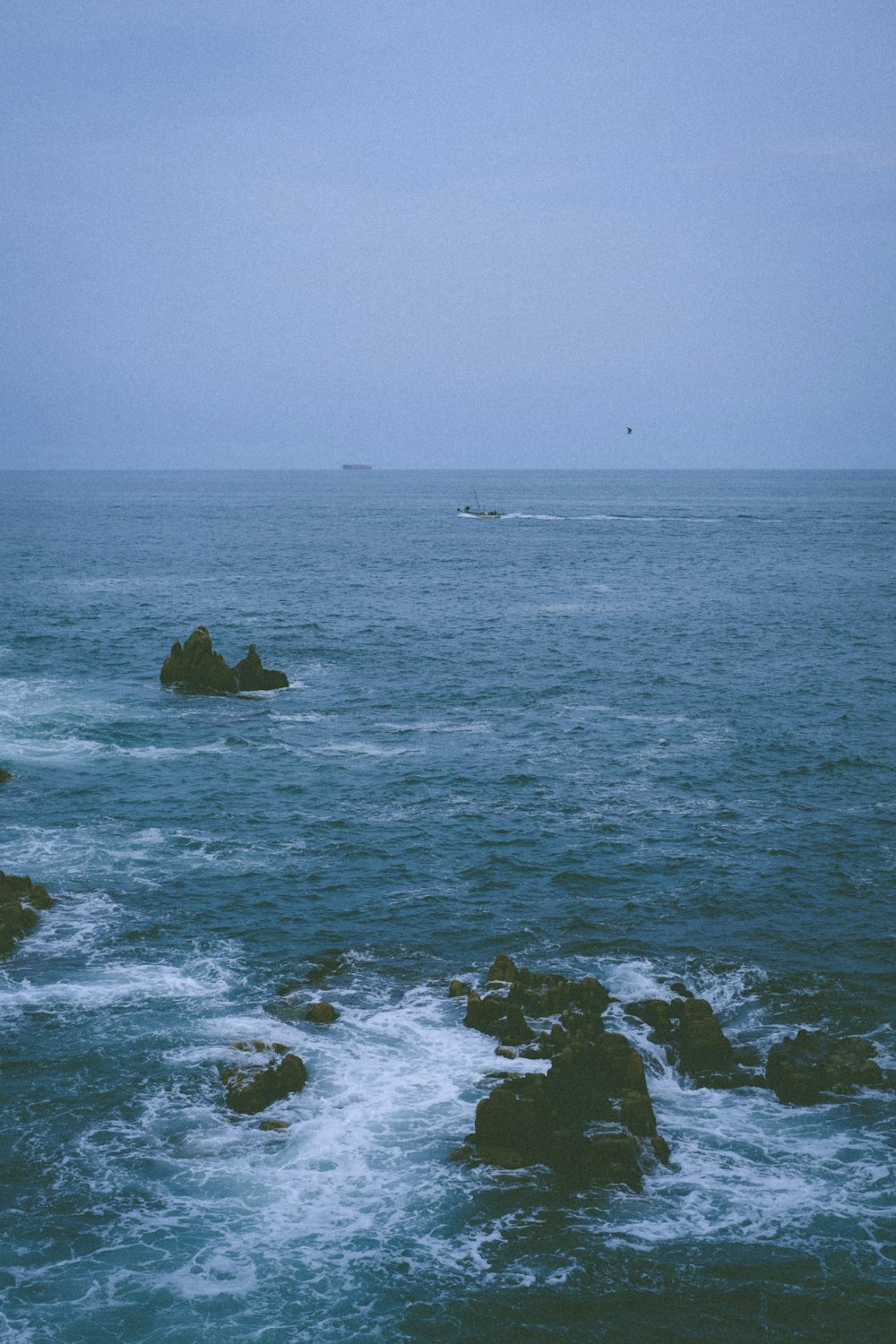 a body of water with rocks and a boat in it