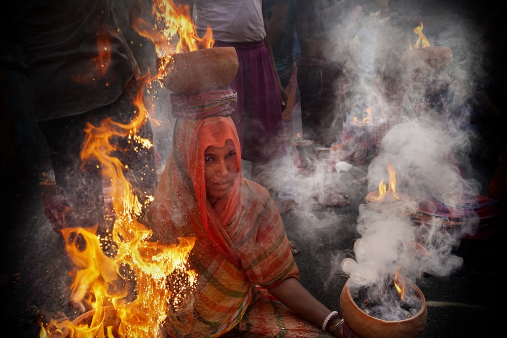 a person sitting in front of a fire