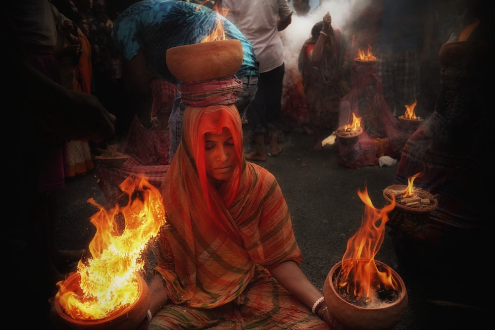 a person sitting next to a fire