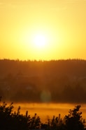 A vibrant sunrise illuminating a peaceful landscape.