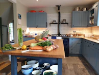 Cozy kitchen with blue and yellow accents reflecting imoveis.aux brand colors