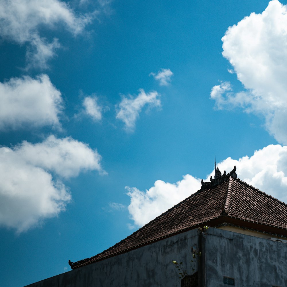 a building with a blue sky and clouds