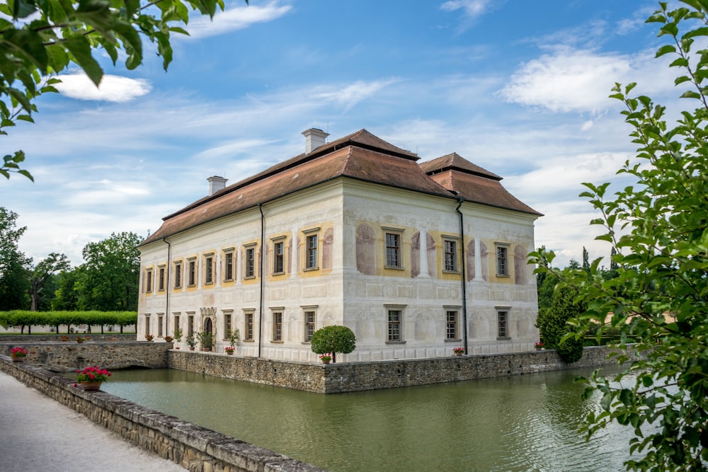 a large house with a pond in front of it