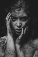 a person with the hand on the face