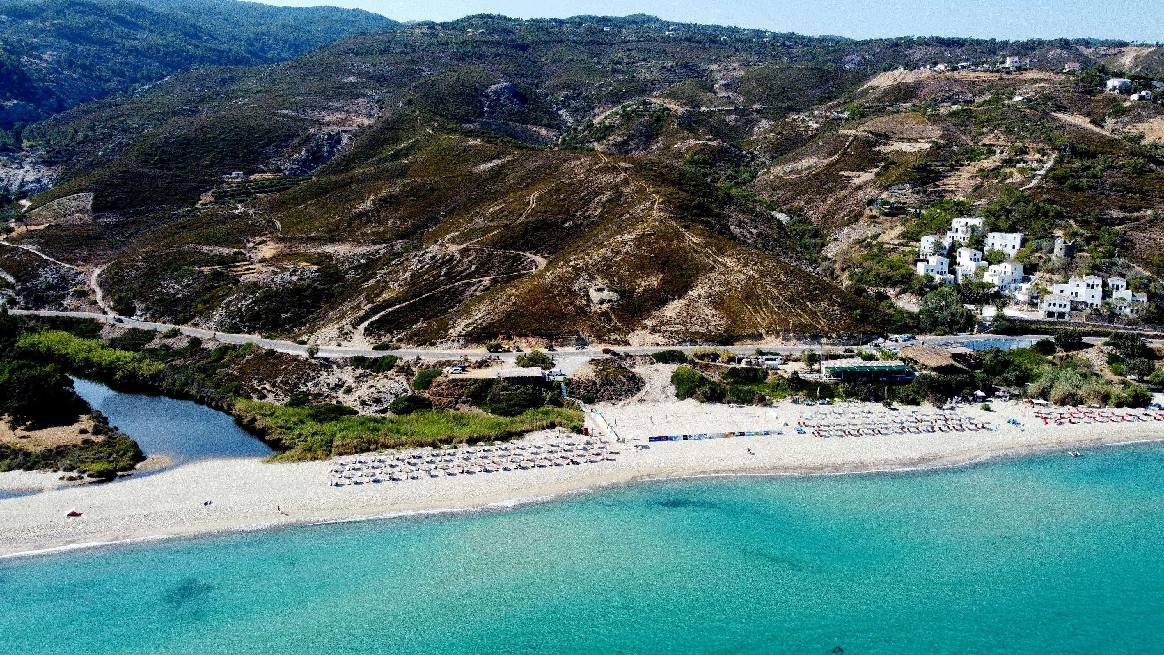 a beach with houses and trees