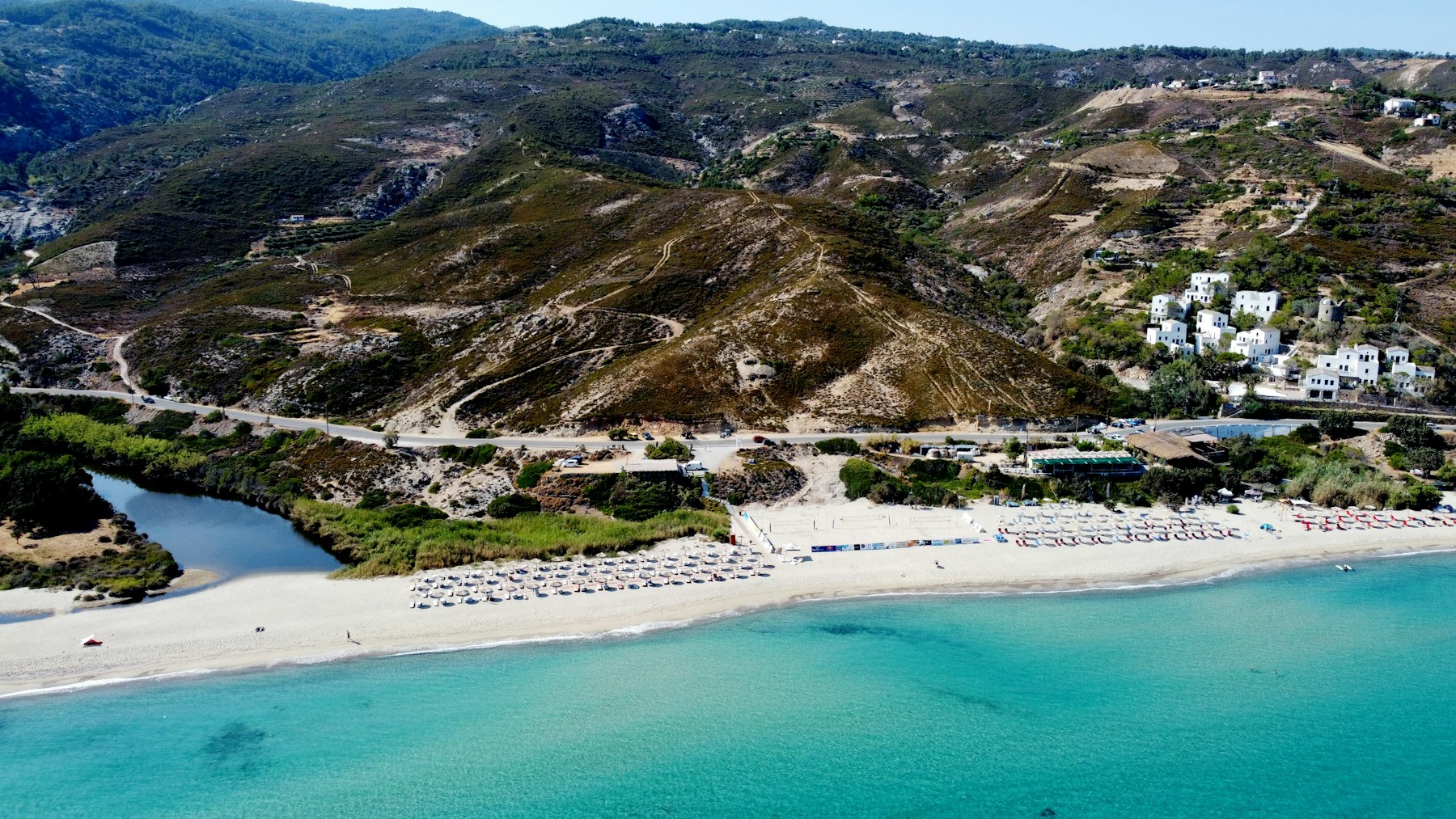Messakti beach and the village of Armenistis on Ikaria's north coast — green mountains meeting the Aegean, Greece