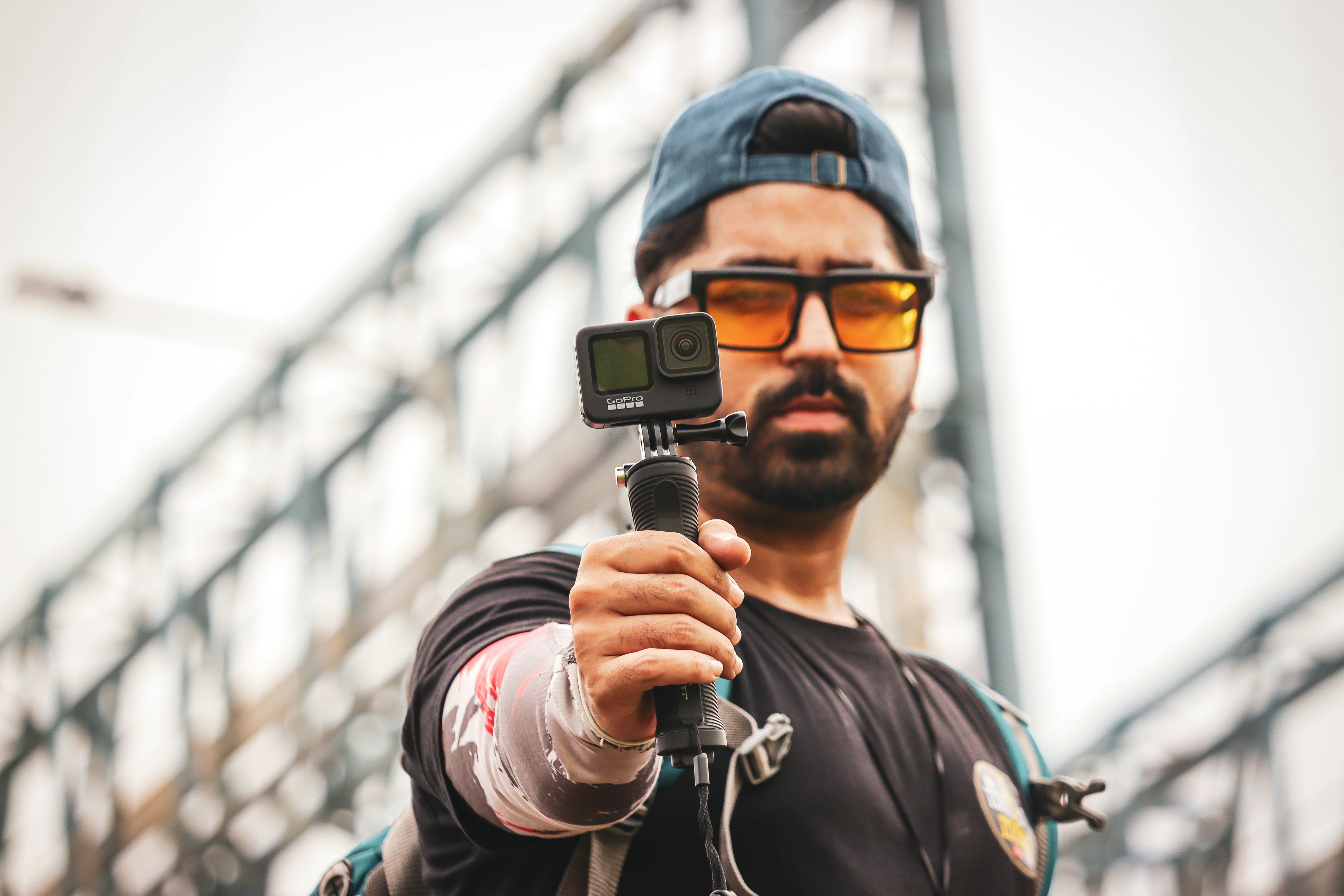 A man shoots footage using a GoPro camera, as he imagines the perfect royalty free vlog sound effects for the shot.