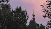 A peaceful outdoor scene showing the church building bathed in soft morning light, inviting visitors.
