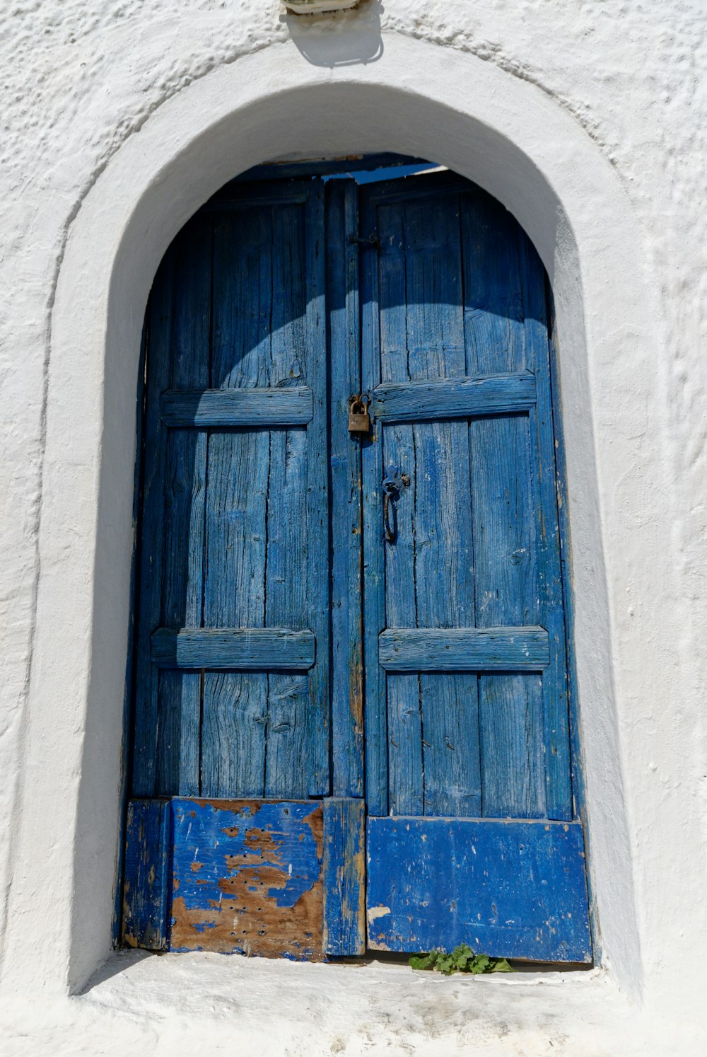 a blue door on a white building