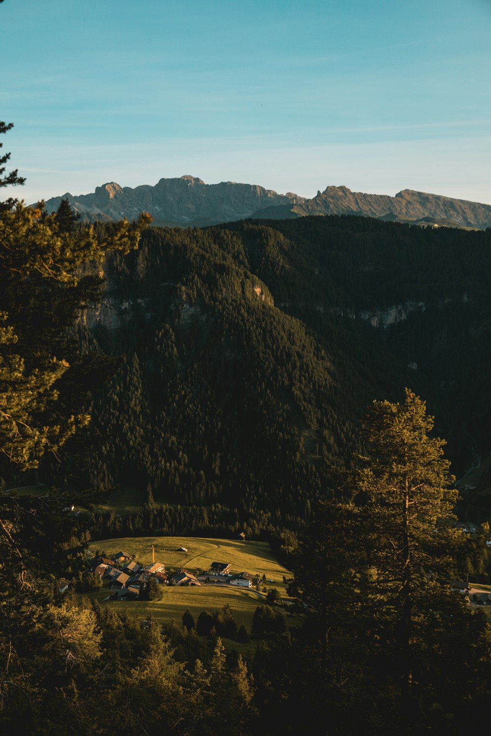 a large rocky mountain with a town below