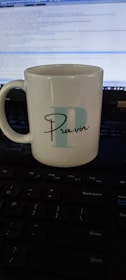 A snapshot of Rajan's favorite coffee mug beside his keyboard, hinting at long coding sessions.