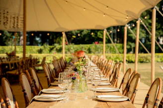 a set dining table with white plates and glasses