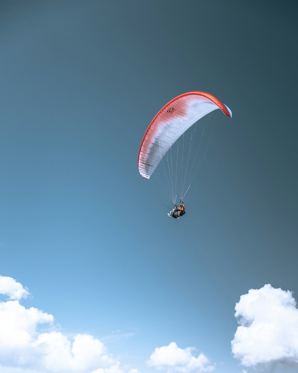 a person in the air with a parachute