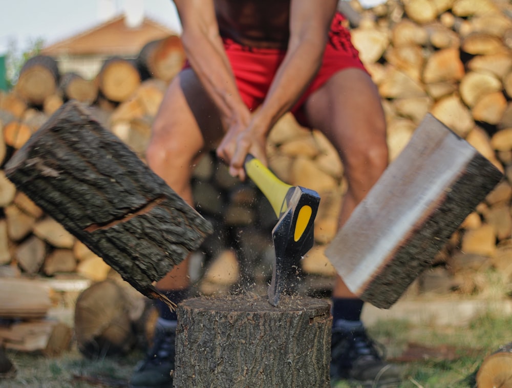 a person cutting wood with scissors