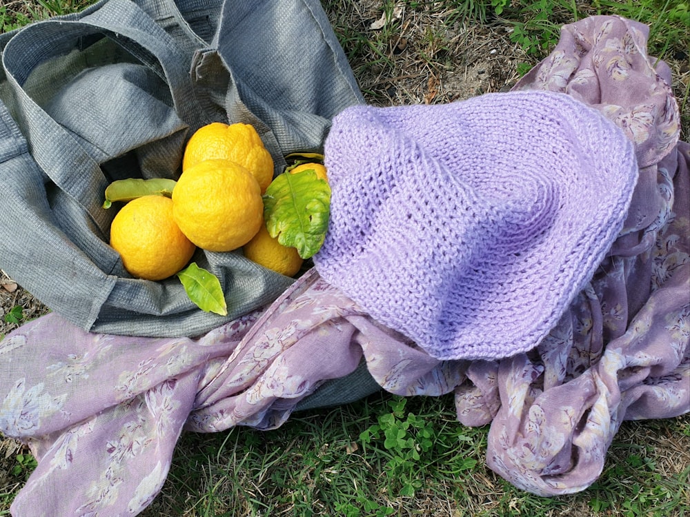 a person lying on the ground with fruit on their back