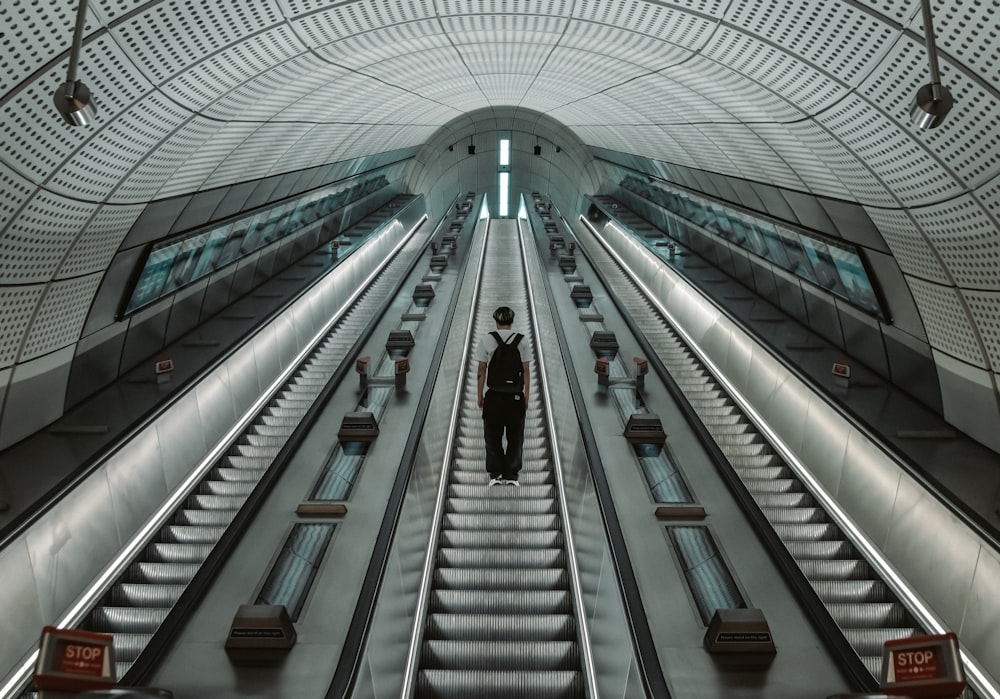 a person standing on a large escalator