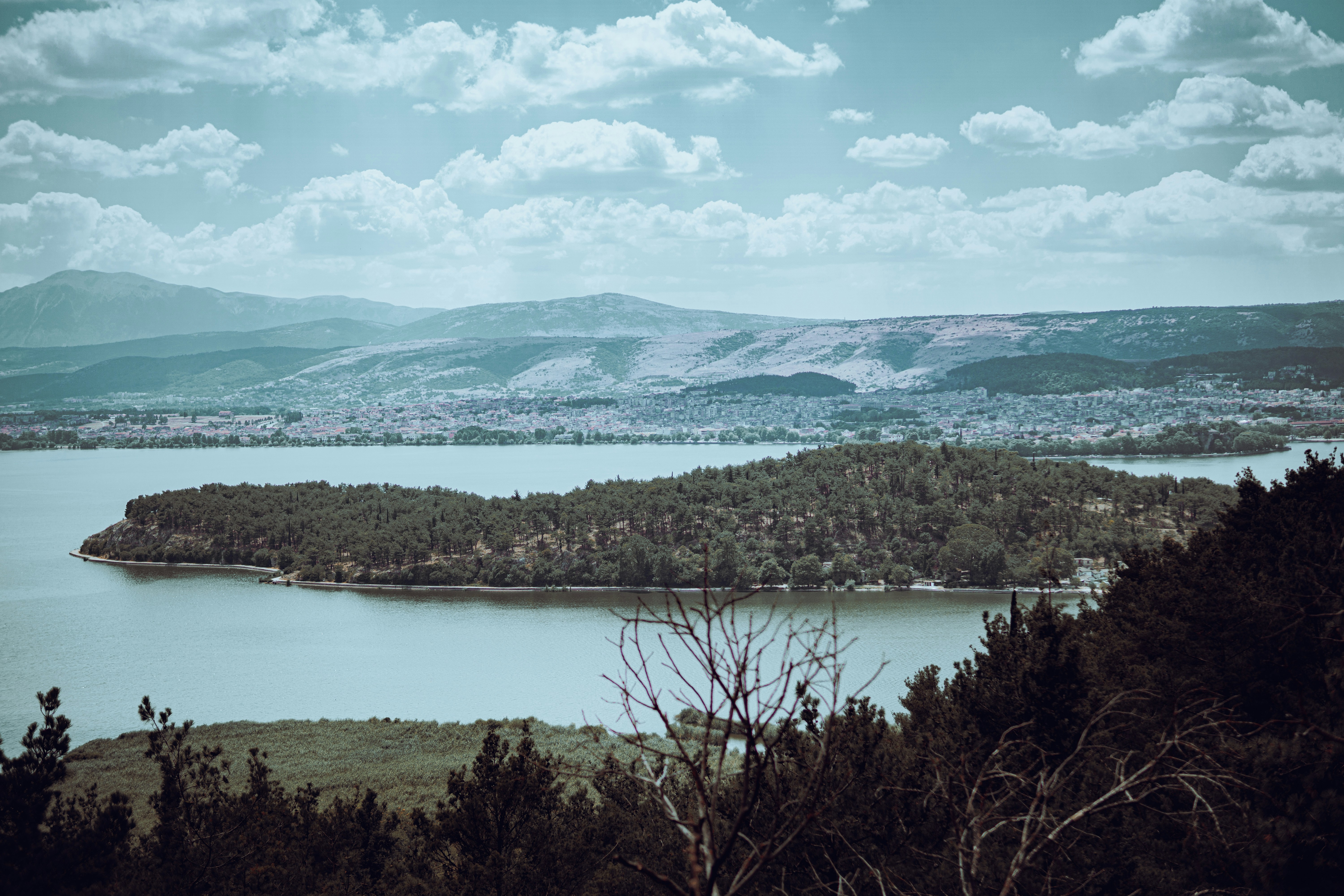 a lake surrounded by trees and mountains