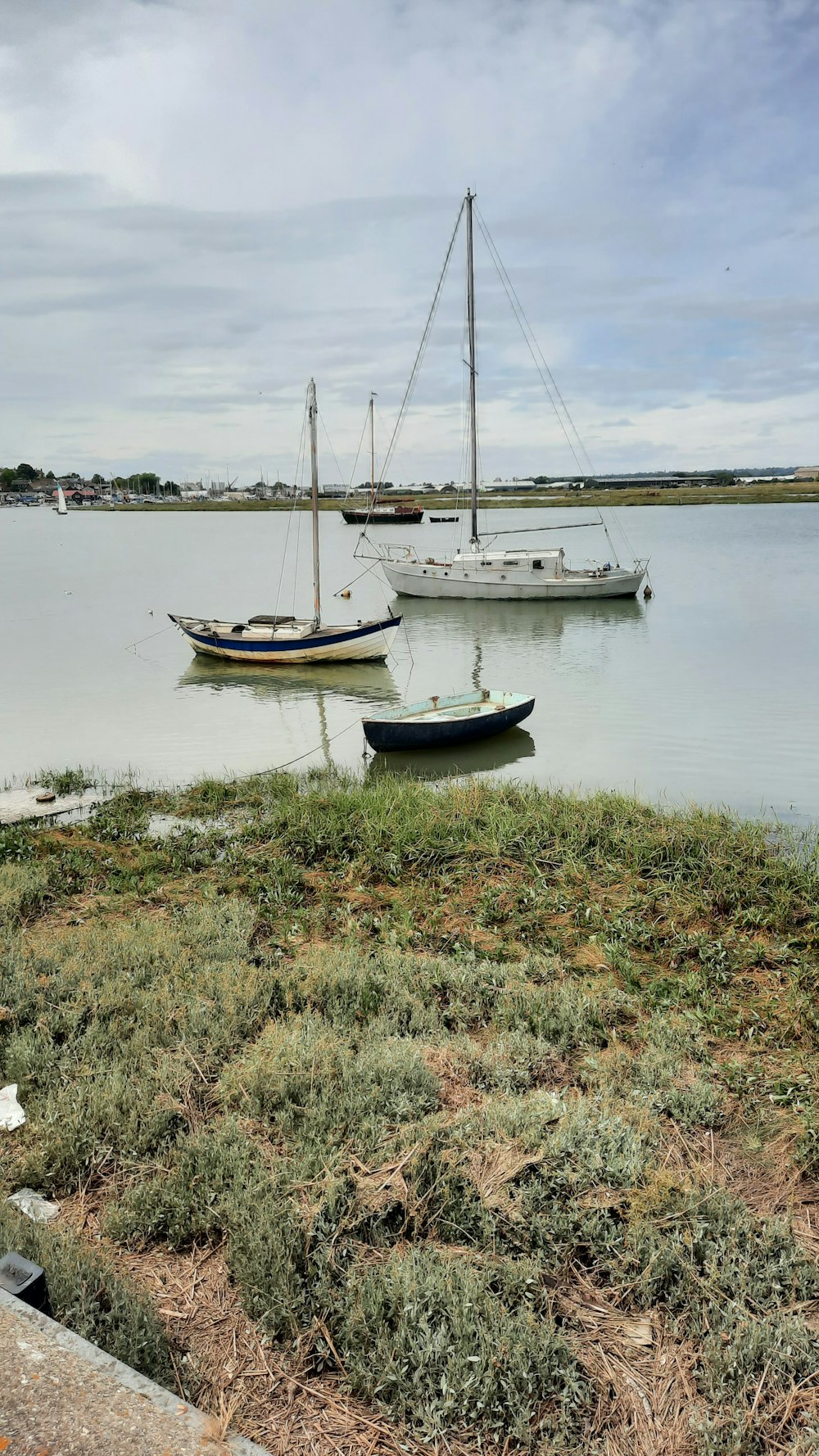 a couple of boats sit in a harbor