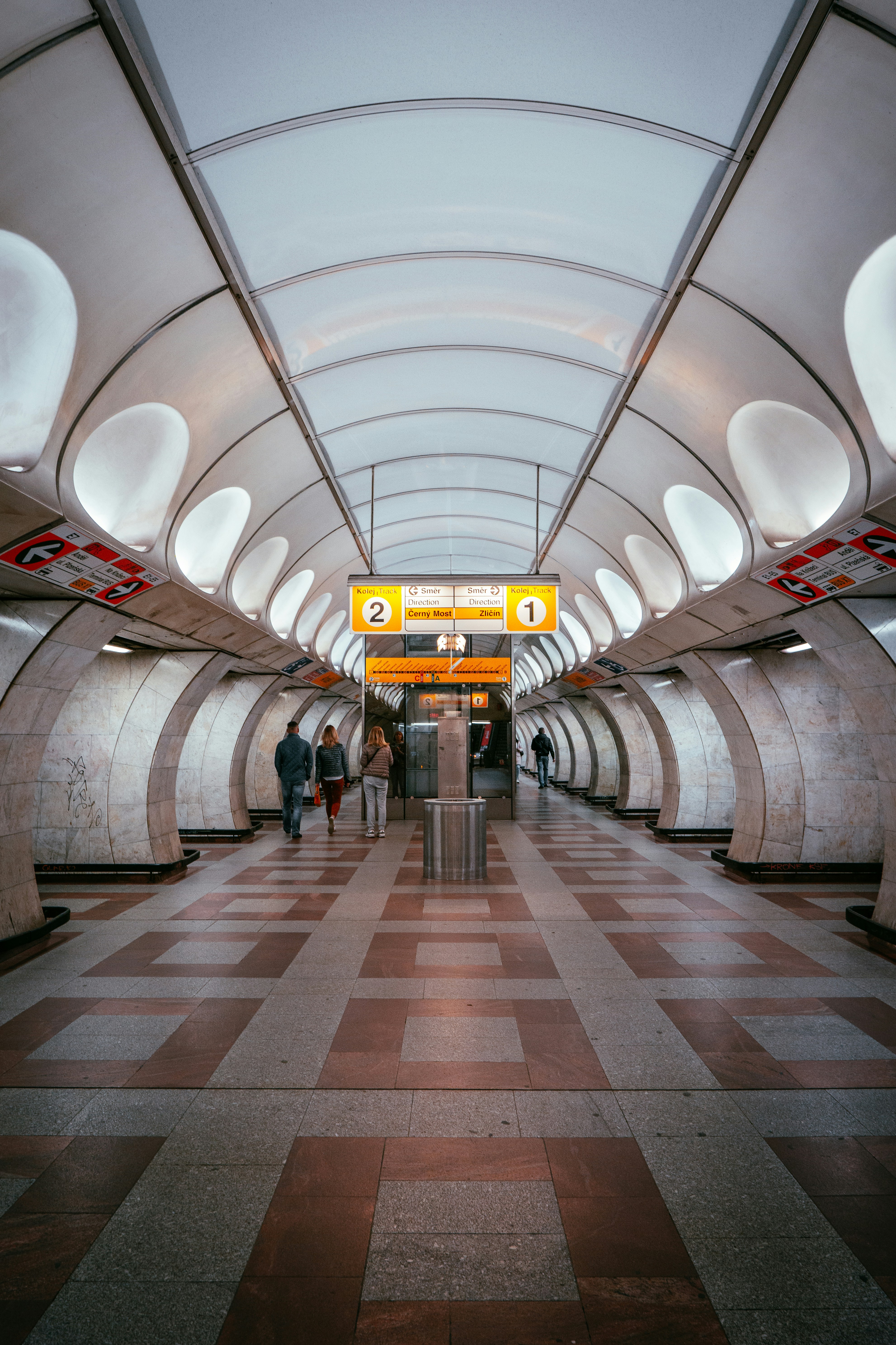 a group of people walking through a tunnel