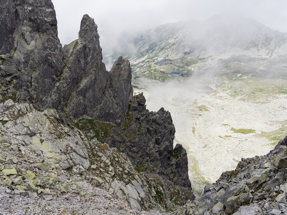 a rocky cliff with a body of water below