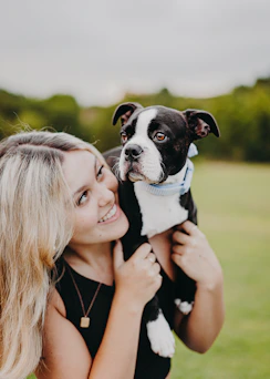 a woman holding a dog