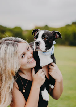 a woman holding a dog