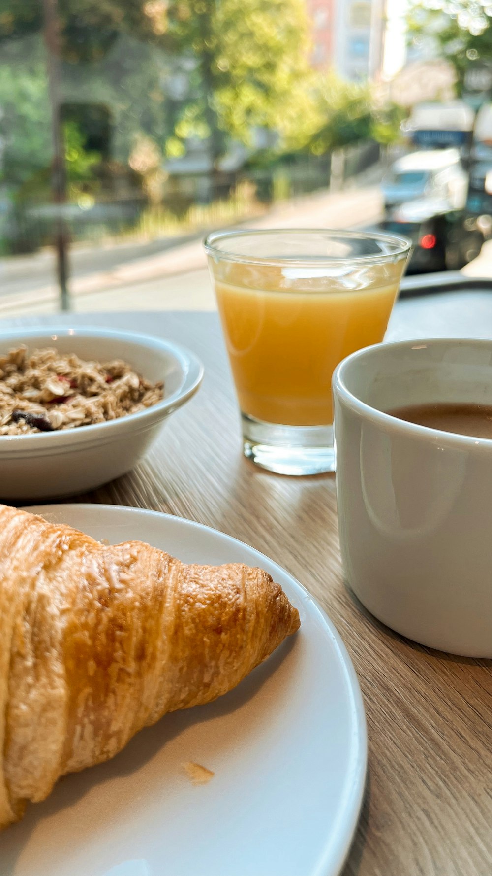 a plate of food and a glass of juice on a table