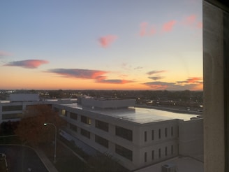 A vibrant city skyline viewed from a high vantage point at dusk.