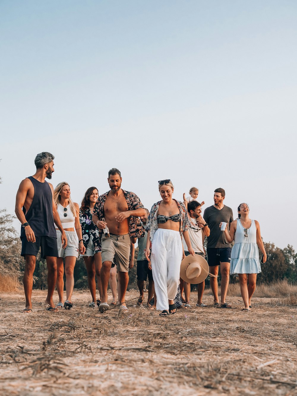 a group of people standing on a beach