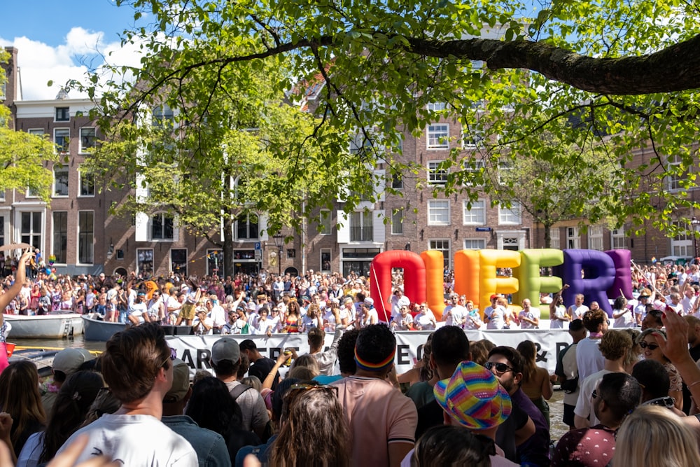 a large crowd of people in a street with La Rambla, Barcelona in the background