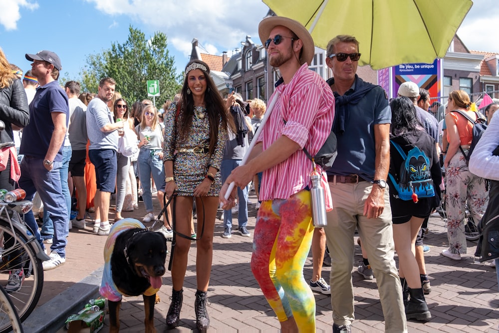 a man and woman walking with a dog